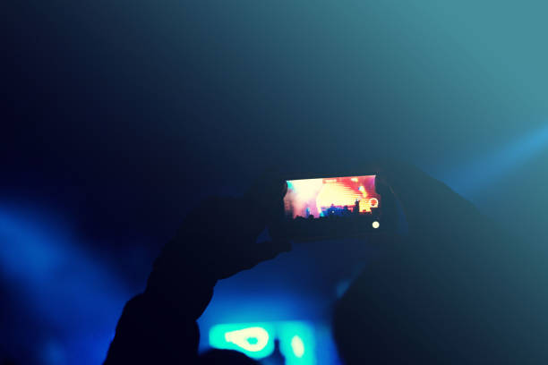 istock filming at concert 825821946