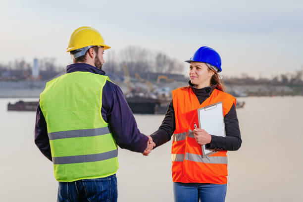 istock Two employees working together at the dock with cargo ships 825822722