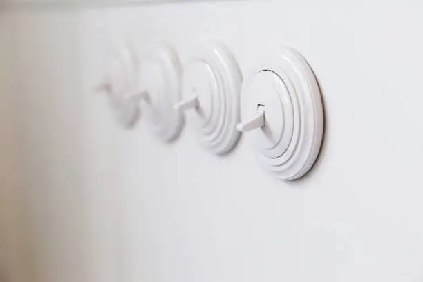 Photo of Light white round switch in off position.