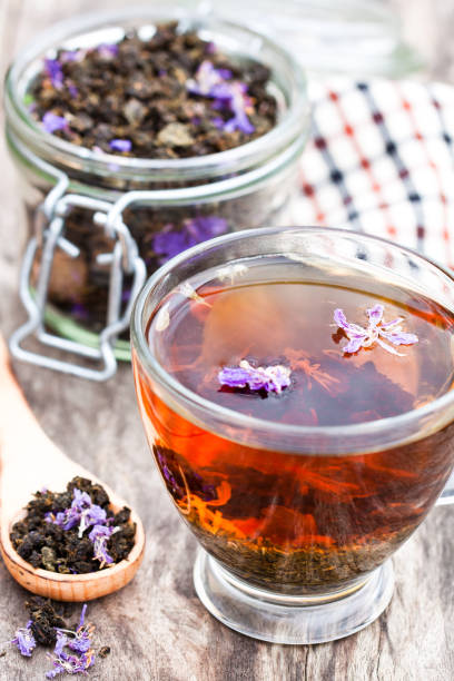 istock cup  of tea with willow-herb on wooden background 825826398