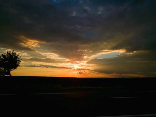 istock amazing sunset trough the storm clouds 825830856