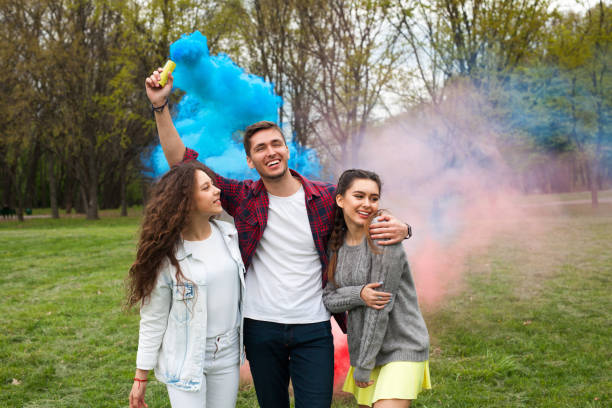 istock Guy with smoke flare and girls 825830902