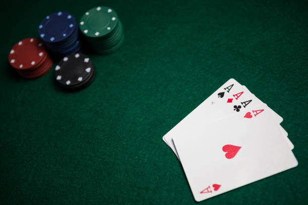 istock Playing cards and casino chips on poker table 825830918