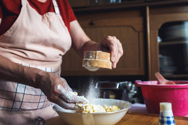 istock Close up of female baker hands kneading dough. 825831002