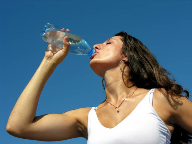 Young woman drinks cold water in hot day Thirst. Young woman drinks cold water in hot day hyperthermia photos stock pictures, royalty-free photos & images