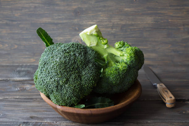istock Fresh broccoli in a wooden bowl on wooden table 825833894