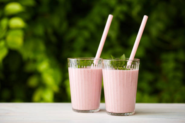 istock Two glasses of strawberry milkshake 825834566