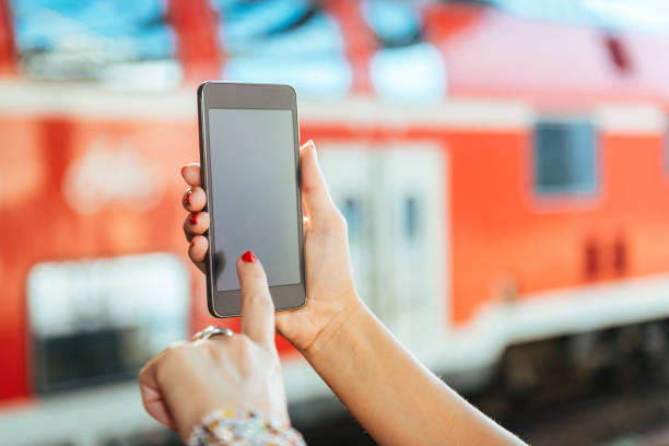 Woman using digital or online platform with departures and arrival for trains and other pulic transport