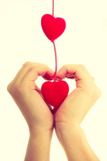istock Female hands with little hearts. 825838098