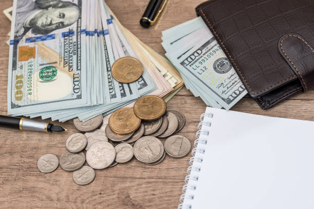 istock notepad with pen, calculator, dollar bills on desk. 825842832