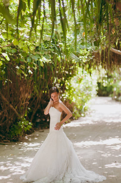 istock Beautiful bride on an island in palms 825845634