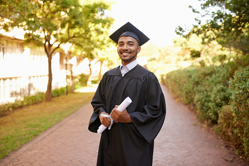 Cropped portrait of a handsome young man posing with his degree on graduation day