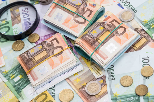 istock magnifying glass and euro banknotes, euro coin 825847570
