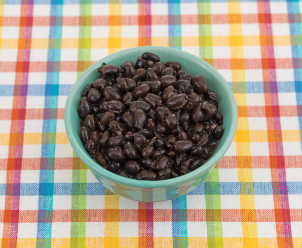 istock Organic black beans in a bowl on a place mat 825850164