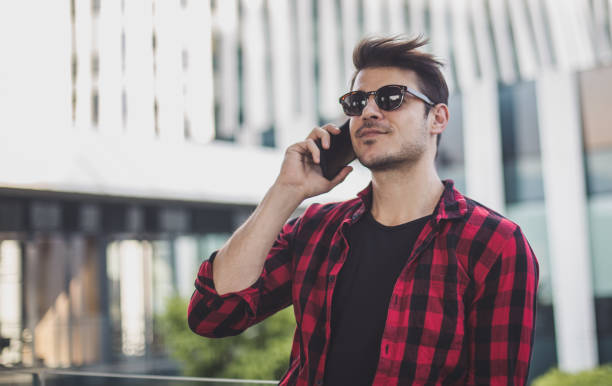 istock Handsome hipster talking on the phone 825854390
