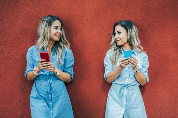 istock Twins texting in the city 825855304