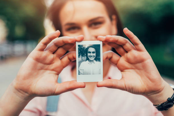 istock Woman holding an instant photo 825855436