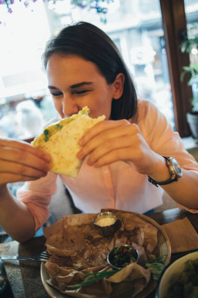 istock Woman eating at a restaurant 825855450