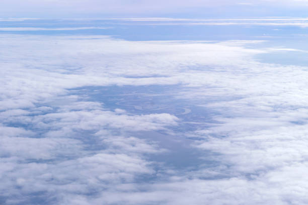 istock Blue sky and Clouds as seen through window of aircraft 825857616