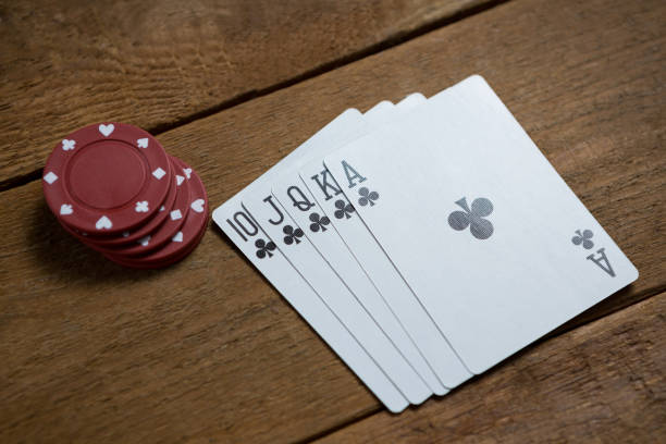 istock High angle view of cards and maroon chips 825858698