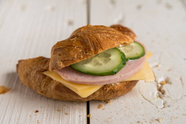 istock Croissant with ham, cheese and cucumber 825860890
