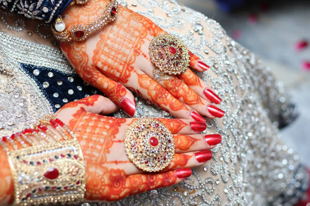 istock Beautifully decorated Asian  bride hands 825861060