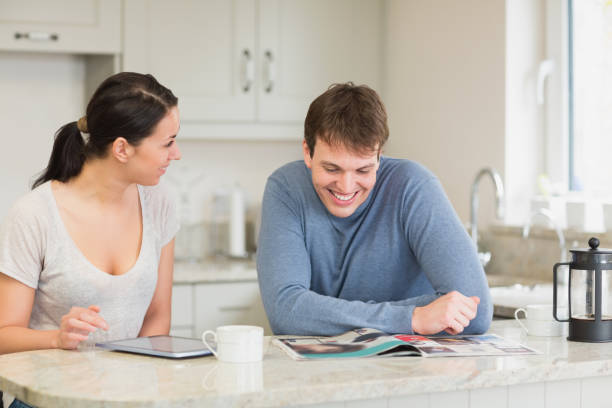 istock Two people sitting in the kitchen and chatting 825861688
