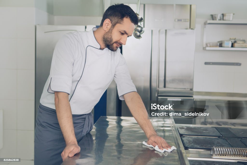 Man japanese restaurant chef working in the kitchen Male japanese restaurant chef working in the kitchen cleaning Cleaning Stock Photo