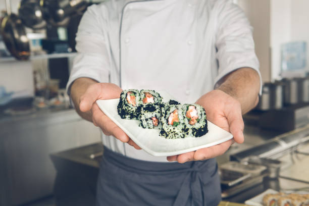 istock Man japanese restaurant chef cooking in the kitchen 825866238