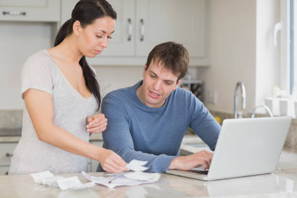 istock Young couple calculating with the laptop 825866266