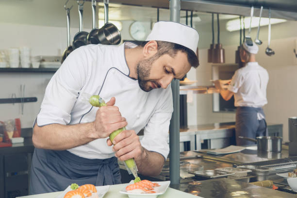 istock Man japanese restaurant chef cooking in the kitchen 825866426