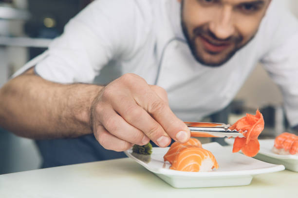 istock Man japanese restaurant chef cooking in the kitchen 825866480