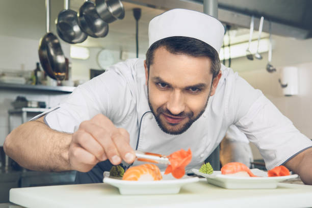 istock Man japanese restaurant chef cooking in the kitchen 825866562