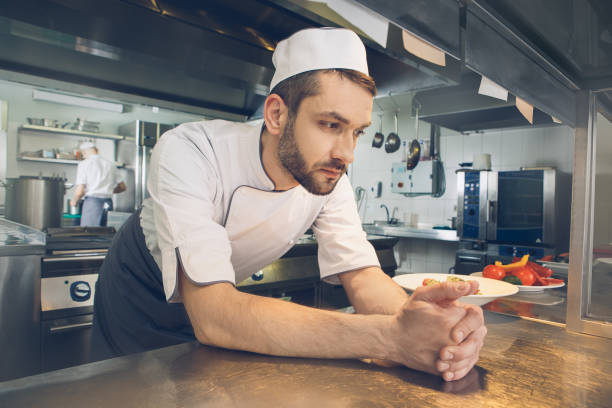 istock Man japanese restaurant chef cooking in the kitchen 825866890