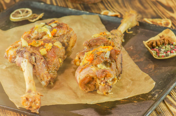 istock Roasted lamb meat with vegetables on wooden background 825866948