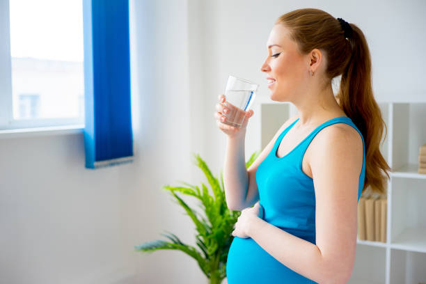 istock Pregnant woman drinking water 825870556