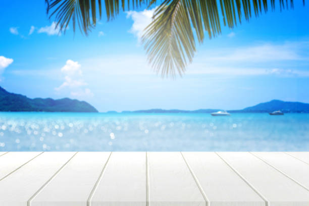 istock white wooden table and beautiful sea in summer. 825874906
