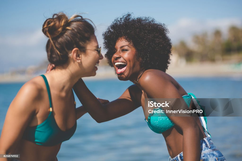 Two best female friends laughing together at seaside Portrait of two best female friends laughing together at seaside Friendship Stock Photo