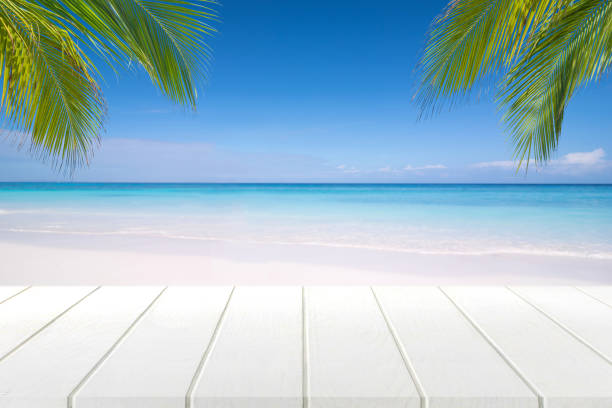 istock white wooden table and beautiful sea in summer. 825875294
