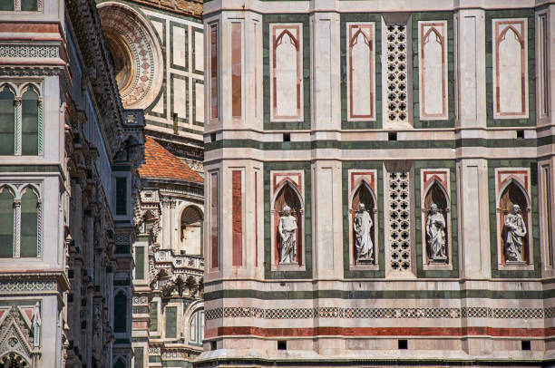 view of detail carved in marble from the cathedral santa maria del fiore and giotto's campanile (bell tower) in florence - rose window florence italy cathedral tuscany imagens e fotografias de stock