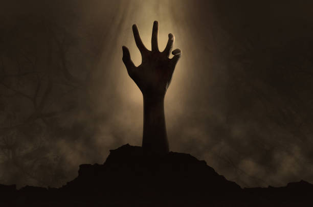 istock Halloween concept, zombie hand coming out 825875494