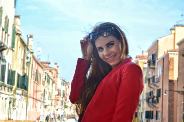 istock Young girl with red jacket and white trousers 825881784