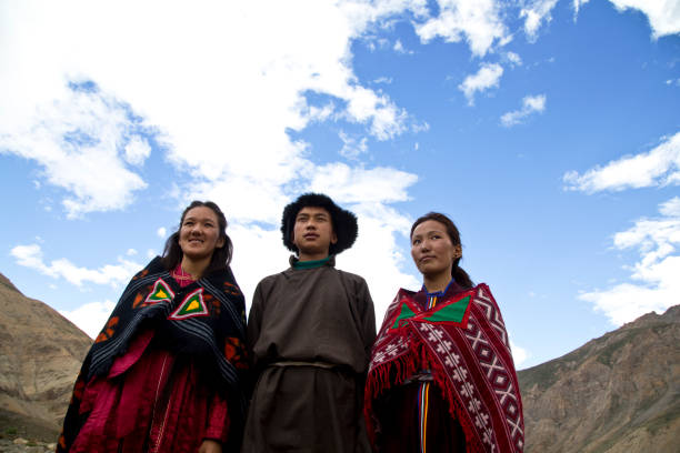 Buddhist man and women posing in front of mountains