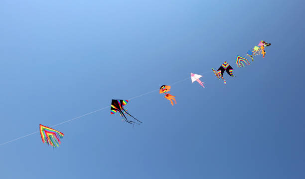 istock Kites fly high in the sky in summer 825886234