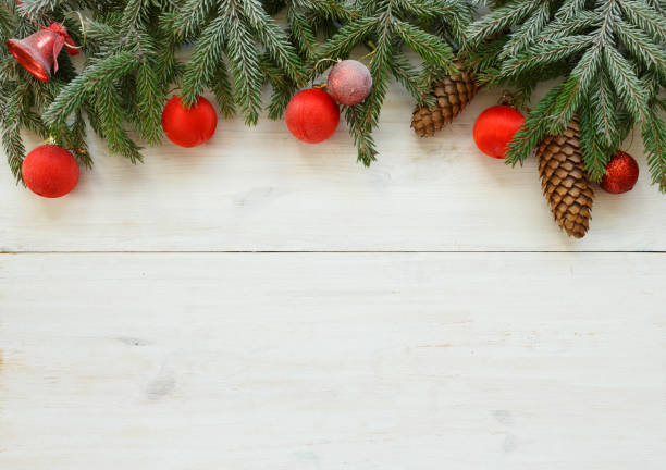 istock Christmas tree branches with cones, christmas decorations on white wooden texture ready for your design 825886548