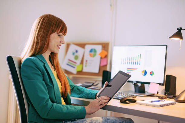 istock Woman working on digital tablet and computer at home 825886556
