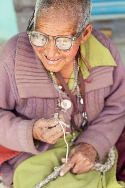 Close-up of elderly woman Close-up of elderly woman wearing sweater at Spiti valley himachal pradesh India india indigenous culture indian culture women stock pictures, royalty-free photos & images