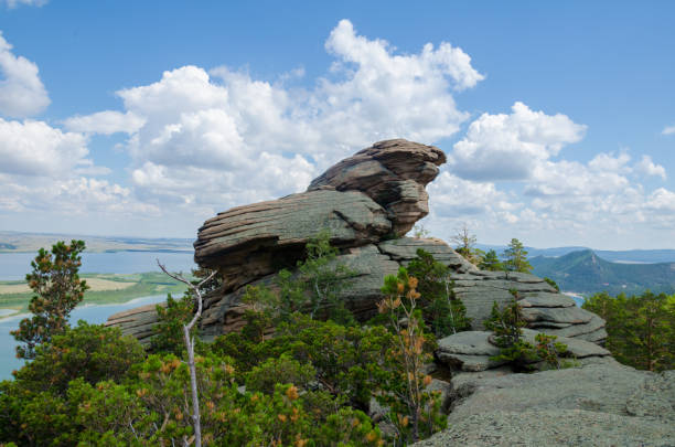 istock mountain peak beautiful unusual stone rising to the clouds. Trees on top 825896170