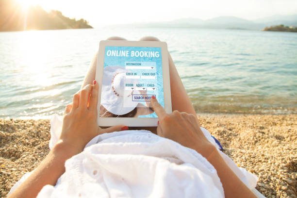 istock Woman holding tablet computer with app hotel booking 825898776