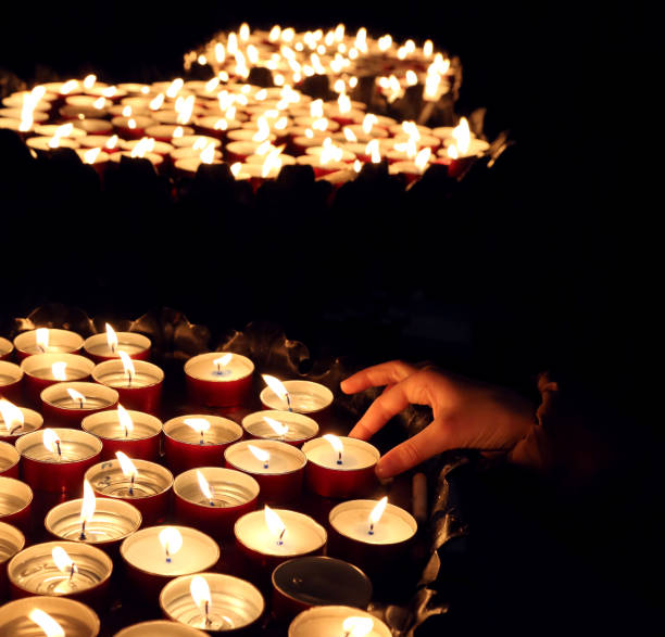 istock person lights a candle during the religious ceremony 825899112